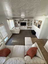 Tiled living area with a textured ceiling