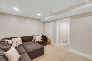 Carpeted living room featuring recessed lighting