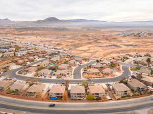 Aerial view of property's location with a mountainous background and nearby suburban area