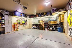 Garage featuring a workshop area and a garage door opener