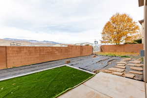 Fenced backyard with a patio area and a mountain view