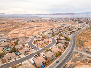 Aerial overview of property's location with a mountainous background and nearby suburban area