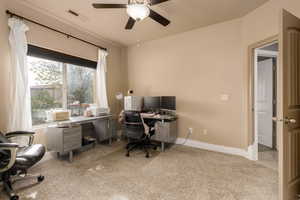 Office area featuring light carpet and ceiling fan