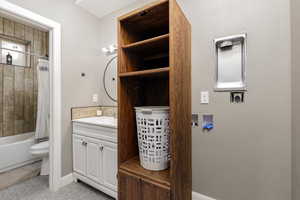 Bathroom featuring vanity and shower / bath combination with curtain