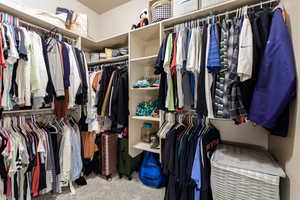 Walk in closet featuring light carpet