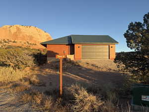 View of side of home featuring a metal roof