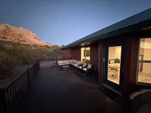 Wooden terrace with outdoor lounge area and a mountain view
