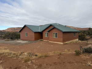 View of side of property featuring a metal roof