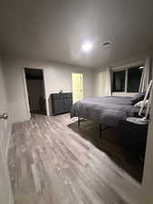 Bedroom featuring a spacious closet and light wood-type flooring