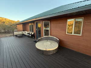 Wooden terrace featuring an outdoor living space