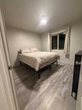 Bedroom featuring light wood-style flooring and baseboards