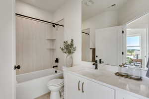 Bathroom with shower / bathtub combination with curtain, vanity, and light tile patterned flooring