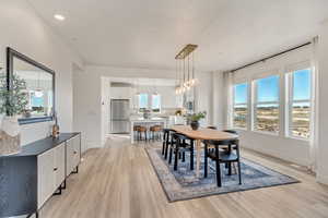 Dining space featuring light wood-style flooring, recessed lighting, and a chandelier