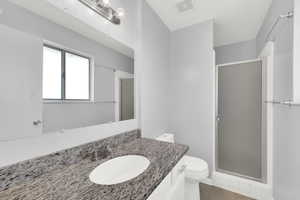 Full bath with vanity, a stall shower, and light tile patterned floors