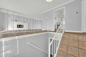 Staircase featuring crown molding