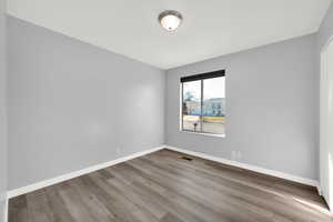 Unfurnished room featuring light wood-style flooring and baseboards
