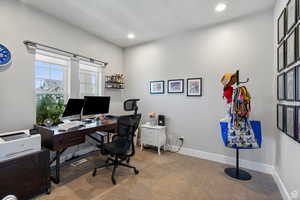 Office area with carpet flooring and recessed lighting