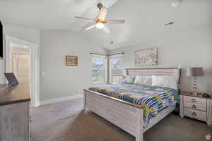 Bedroom featuring vaulted ceiling, carpet, a textured ceiling, and a ceiling fan