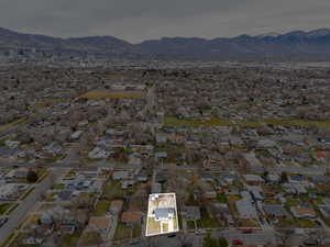 Aerial overview of property's location featuring a mountain backdrop and nearby suburban area
