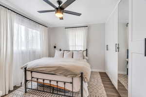 Bedroom featuring wood finished floors and ceiling fan