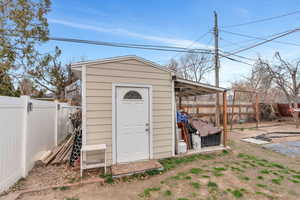 View of shed featuring a fenced backyard