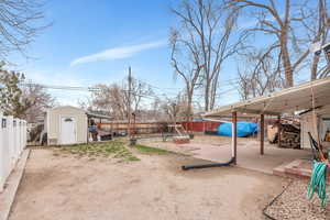 Fenced backyard with a patio and a storage shed