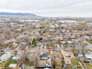 Aerial view of property's location featuring nearby suburban area and a mountain backdrop