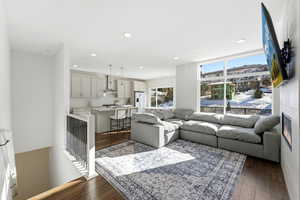 Living room with dark wood-style flooring and recessed lighting