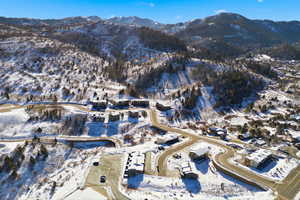 Snowy aerial view featuring a mountain view