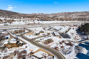 Snowy aerial view featuring a mountain view