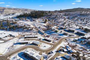 Snowy aerial view featuring a mountain view