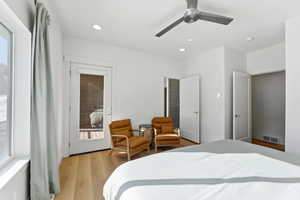Bedroom featuring light wood-style flooring, access to outside, multiple windows, a ceiling fan, and recessed lighting
