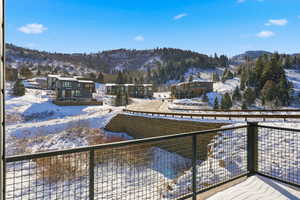 Snow covered back of property featuring a mountain view