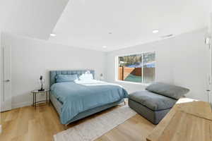 Bedroom with light wood-style floors and recessed lighting