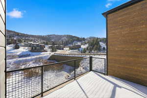Snow covered back of property featuring a mountain view