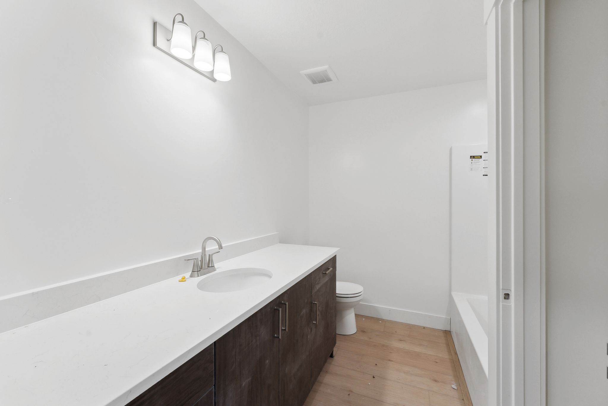 Full bathroom featuring vanity and light wood-type flooring
