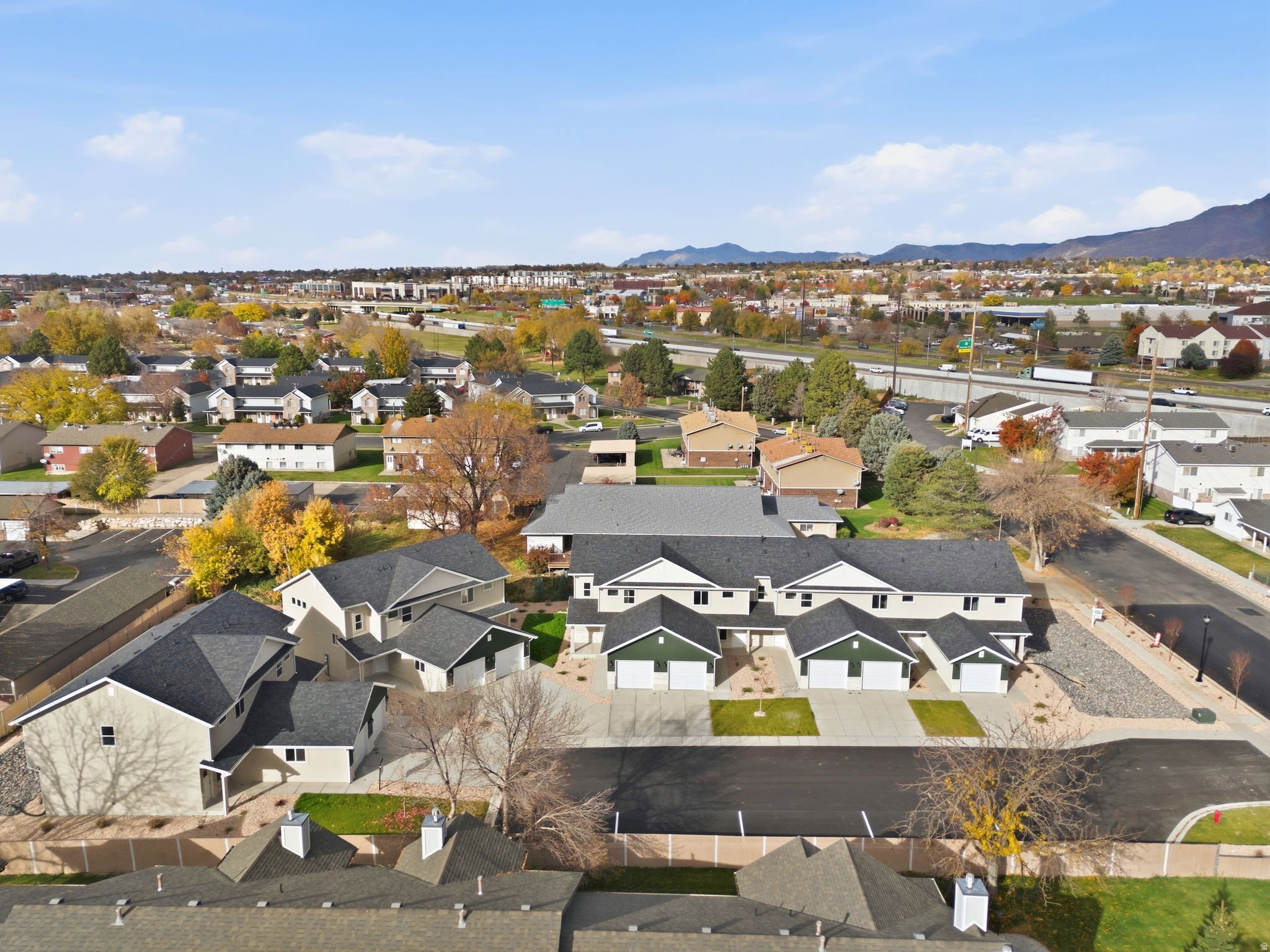 Aerial view of residential area featuring a mountainous background