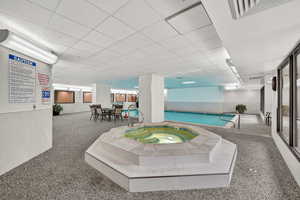 Indoor community pool with a hot tub