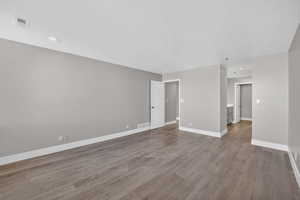 Spare room with dark wood finished floors and recessed lighting