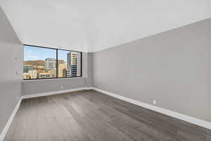 Unfurnished room featuring light wood-type flooring and a view of city