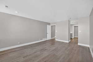 Spare room with light wood-style floors and recessed lighting