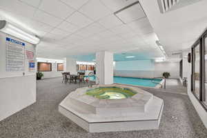 Community pool featuring an in-ground hot tub