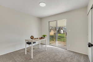 Home office with carpet flooring and baseboards