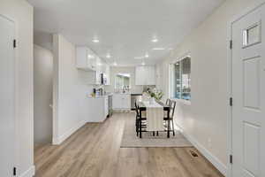 Dining room featuring light wood-style flooring and recessed lighting