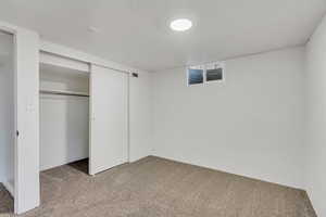 Unfurnished bedroom featuring a closet and carpet floors