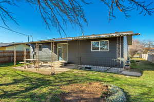 Rear view of house with a patio area and entry steps