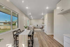 Dining space with light wood-type flooring and recessed lighting