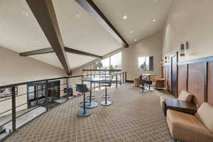 Community lobby featuring beamed ceiling, high vaulted ceiling, and recessed lighting
