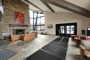 Community lobby featuring high vaulted ceiling and beam ceiling