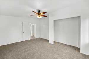 Unfurnished bedroom with carpet and ceiling fan